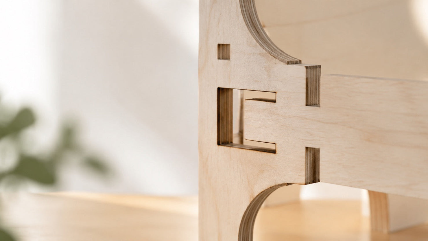 Macro detail of laser-cut birch wood interlocking joints, illustrating the precise friction-fit engineering behind modern 3D wooden puzzles.