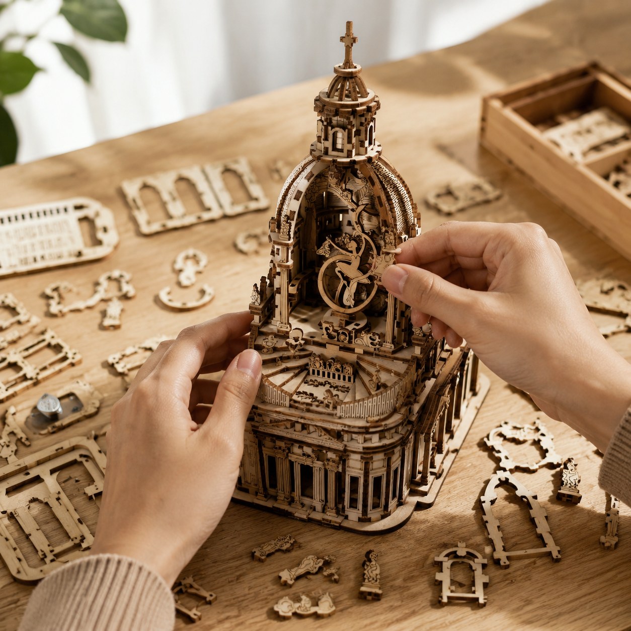 Adult hands assembling the wooden Swan Lake music box on a workbench