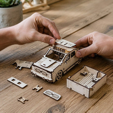 Adult hands assembling a wooden pickup truck 3D puzzle on a workbench
