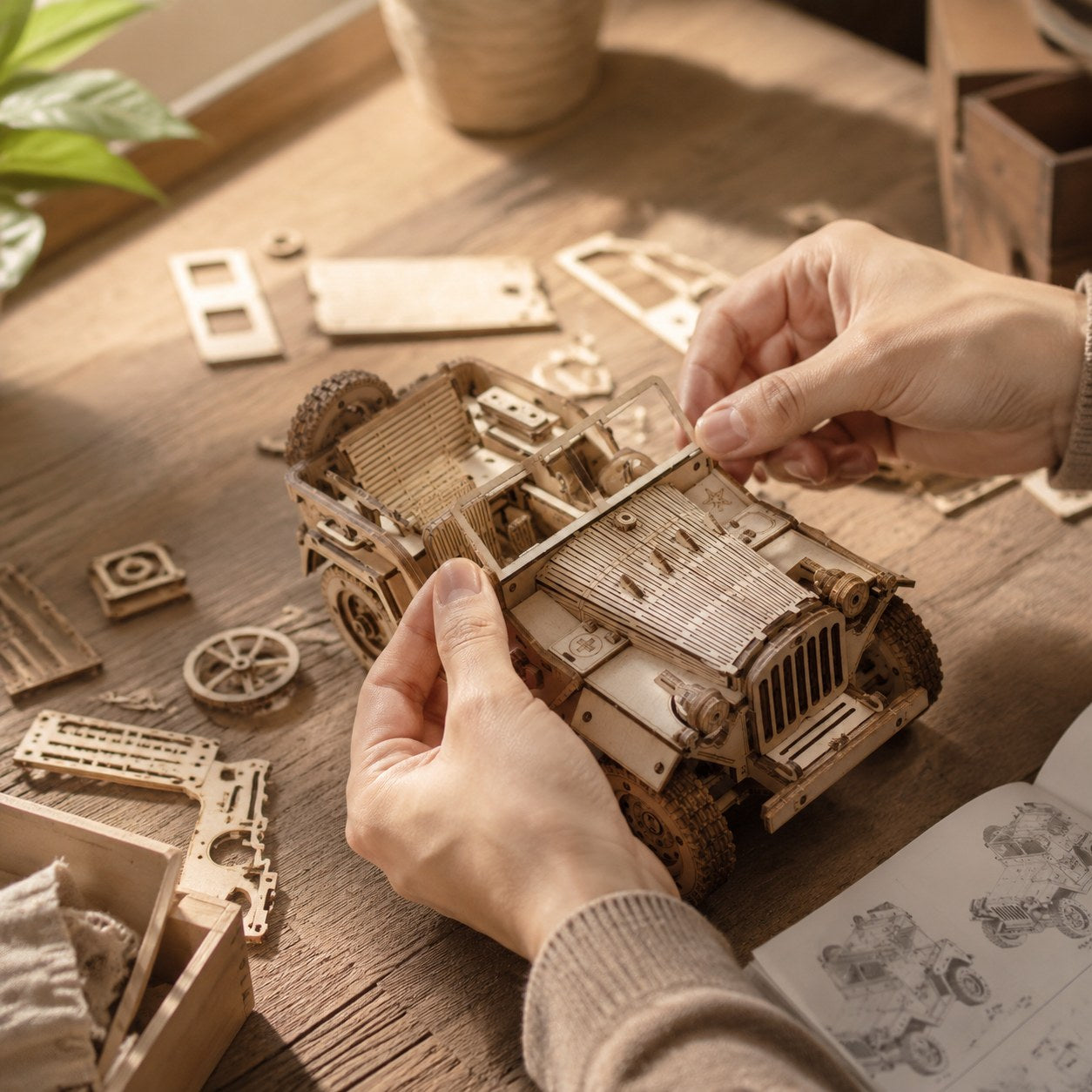Adult hands assembling a vintage off-road vehicle 3D wooden model kit on a wooden workbench.