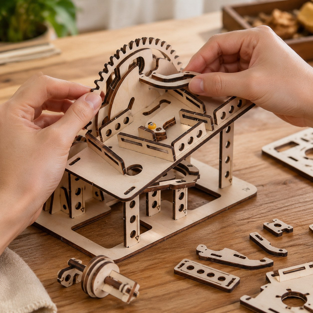 Adult hands assembling the wooden marble run puzzle on a workbench