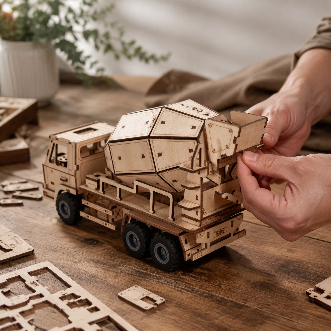 Person assembling the wooden cement mixer model