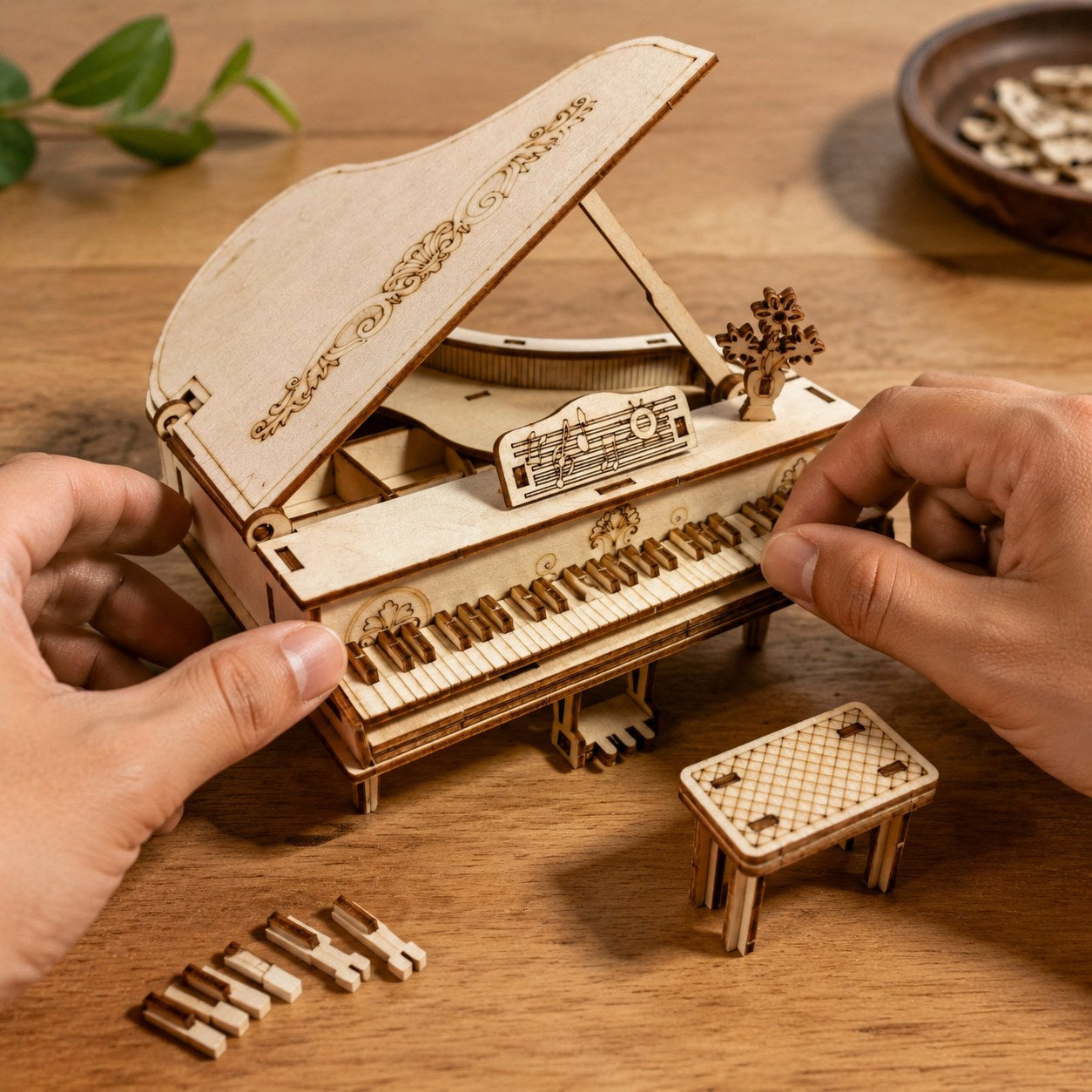 Adult hands assembling the wooden grand piano puzzle on a workbench