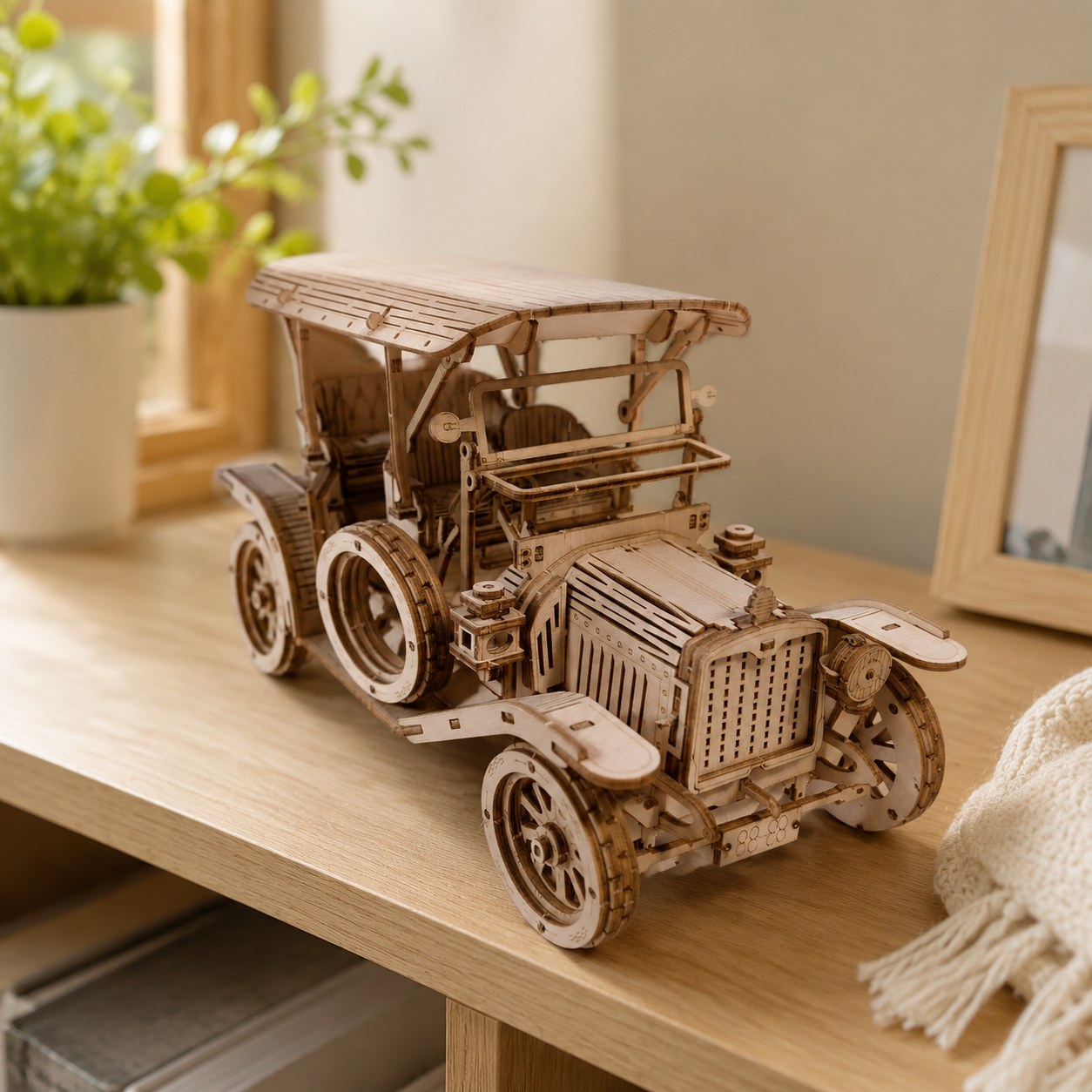 Assembled Retro Roadster Mechanical Wooden Car Kit displayed on a wooden desk.