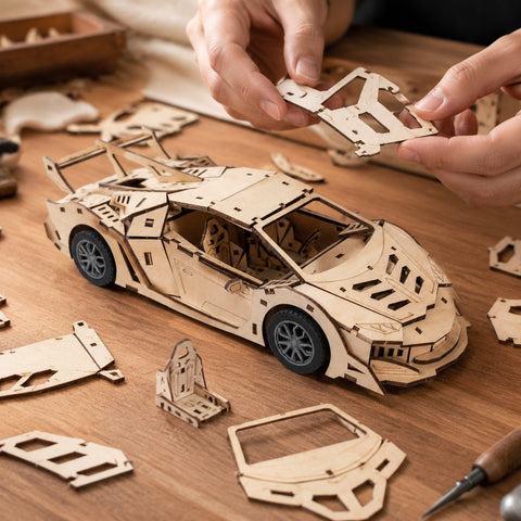 Adult assembling the wooden supercar model on a workbench