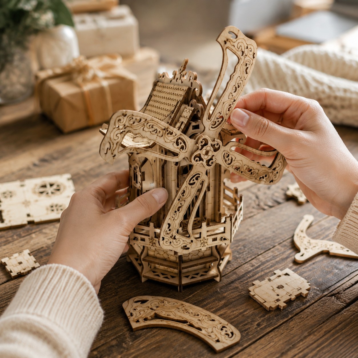 Person assembling the wooden windmill house puzzle