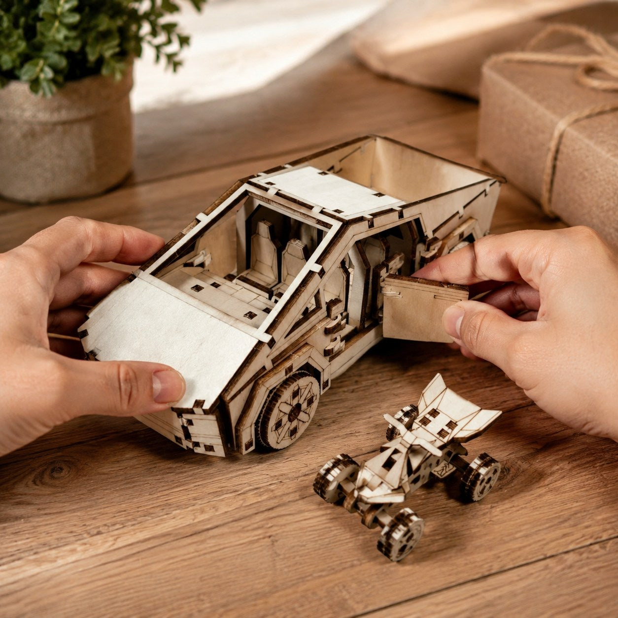 Hands assembling the wooden cyber-style pickup truck model