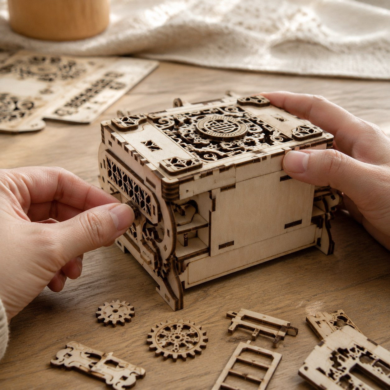 Hands assembling a wooden mechanical jewelry box kit