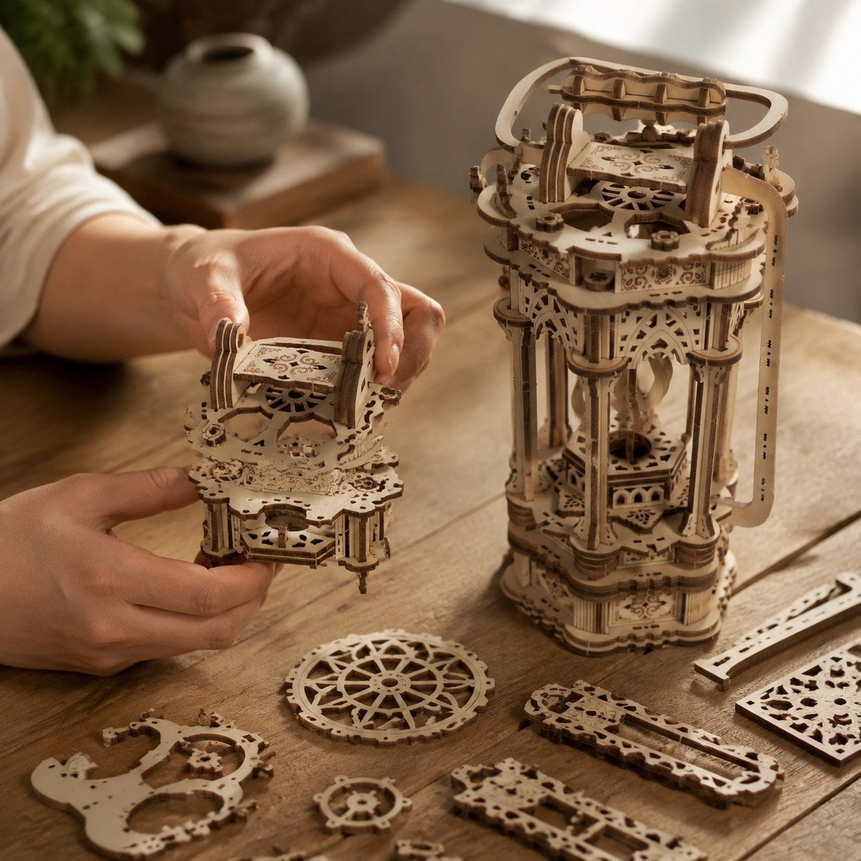 Adult hands assembling the intricate pieces of a wooden Tang lantern model kit.