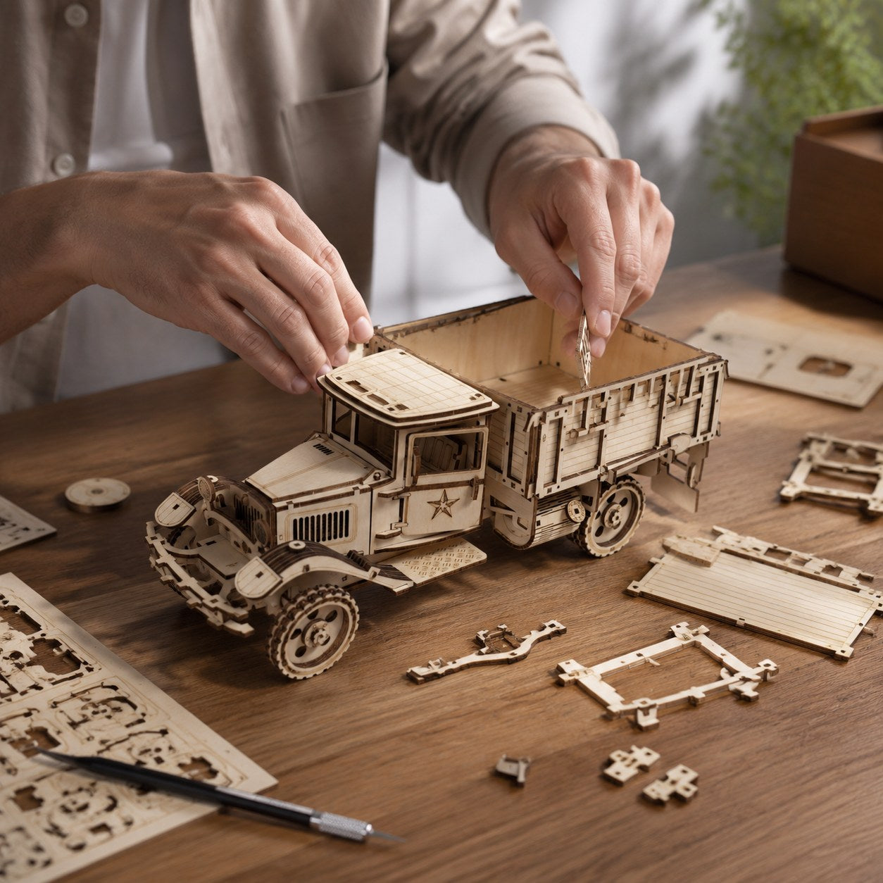 Adult hands assembling the Vintage Cargo Truck 3D Wooden Puzzle on a workbench