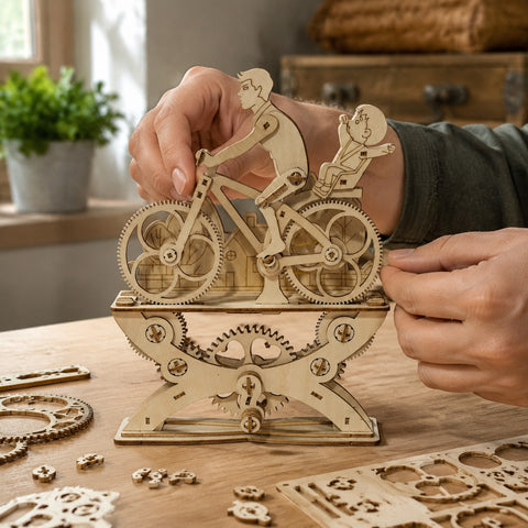Hands building the kinetic wooden bicycle model