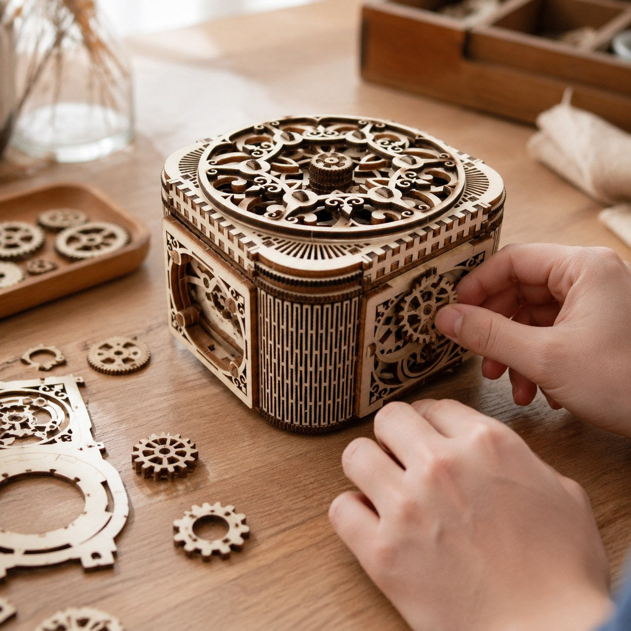 Hands assembling the mechanical jewelry box wooden puzzle