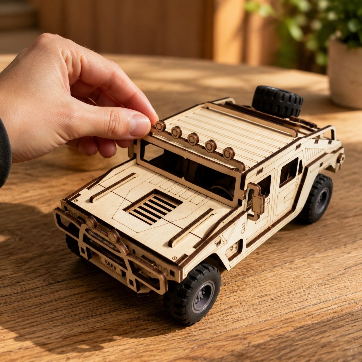 Hand adjusting the finished 3D wooden off-road vehicle puzzle
