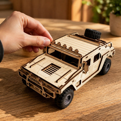 Hand adjusting the finished 3D wooden off-road vehicle puzzle