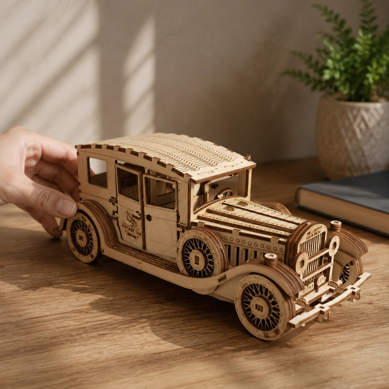Hand adjusting the finished vintage car wooden model showing scale