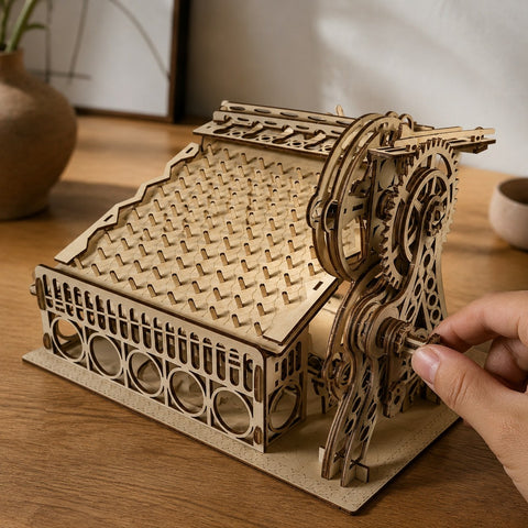 Hand turning the crank on the wooden peg maze model