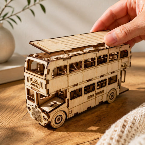 Hand placing a piece on the wooden London bus puzzle for scale