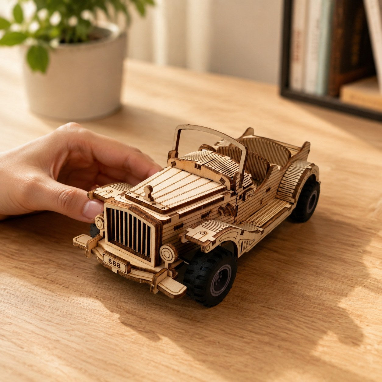 Adult hand next to the assembled Vintage Convertible Car wooden model showing physical scale