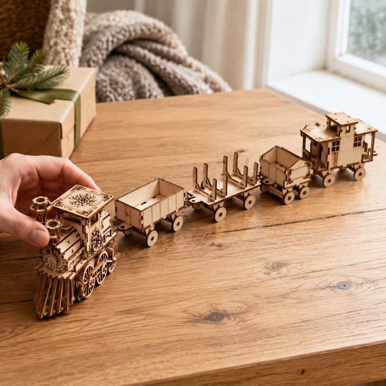 Adult hand adjusting the finished wooden train to show scale
