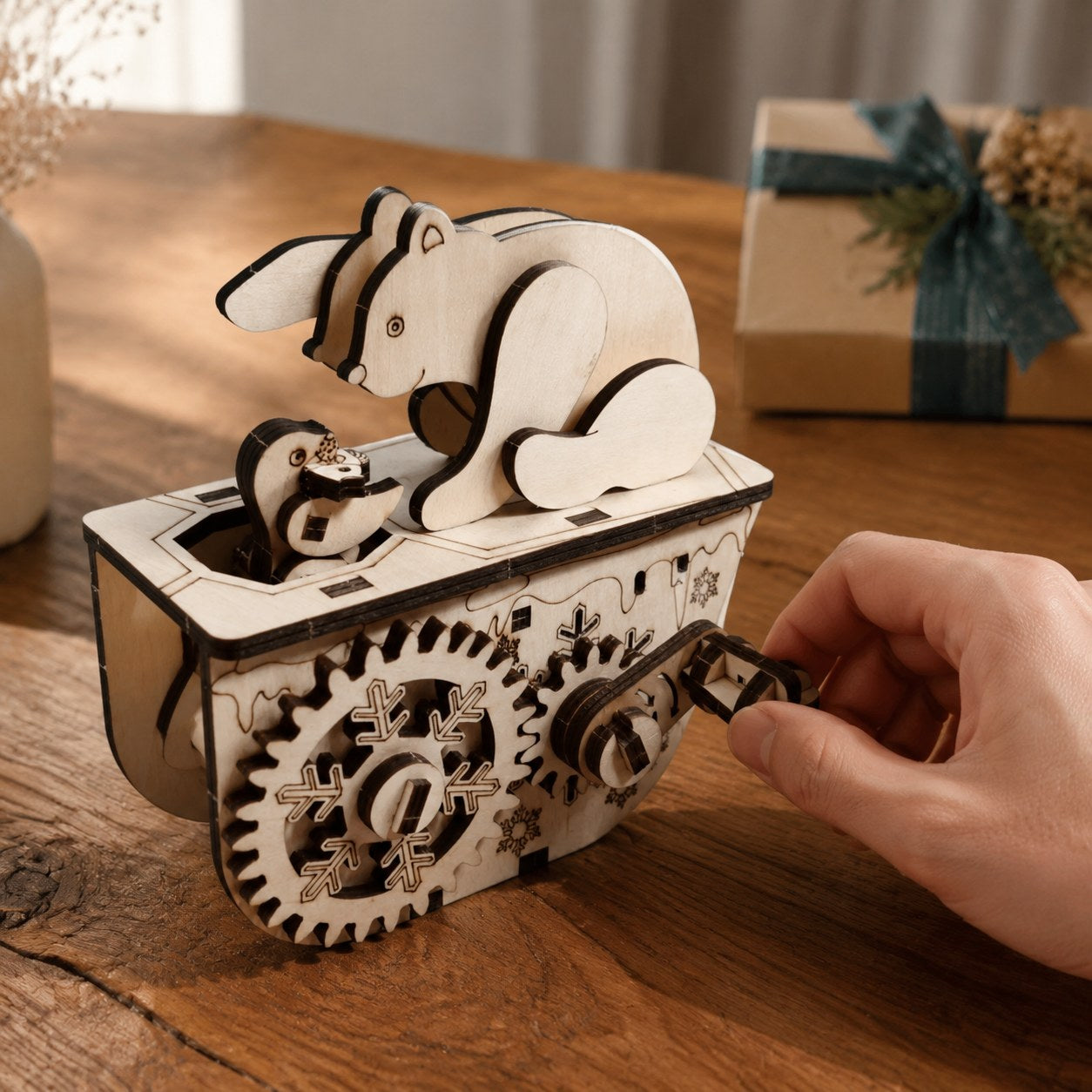 Adult hand turning the crank on the Polar Bear 3D Wooden Puzzle to show scale