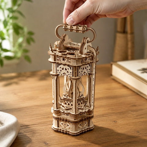 Adult hand holding the decorative carrying handle of the finished Tang lantern puzzle for scale.