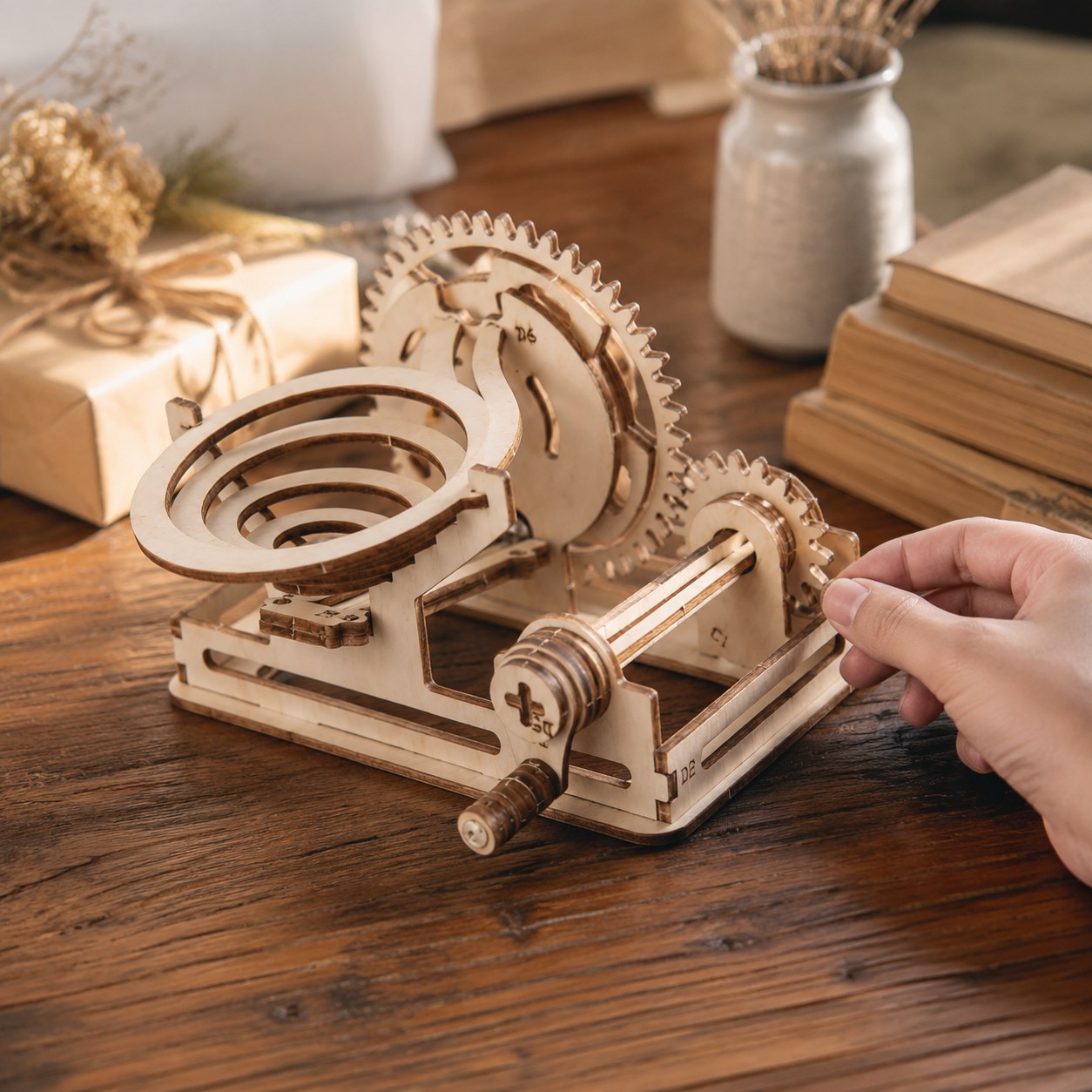 Hand cranking the wooden marble run