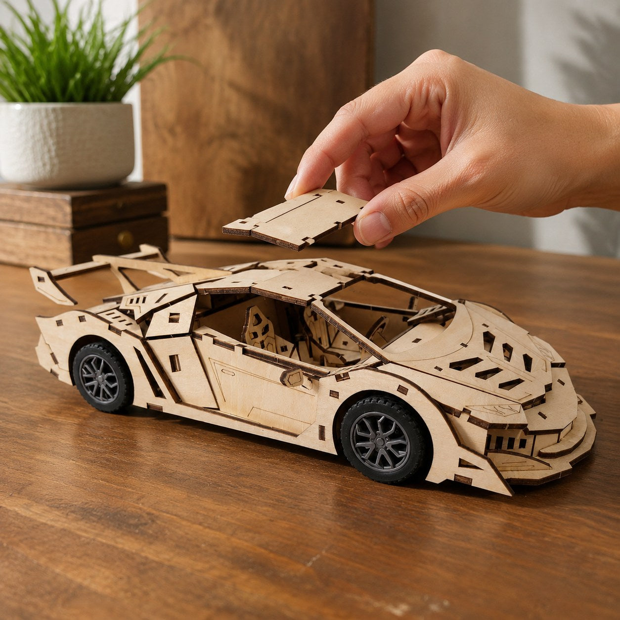 Hand adjusting the finished wooden supercar model to show scale