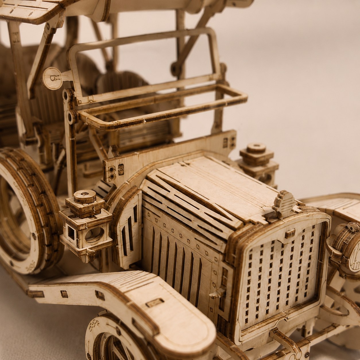 Close-up detail of the laser-cut wood pieces on the Retro Roadster Mechanical Wooden Car Kit.
