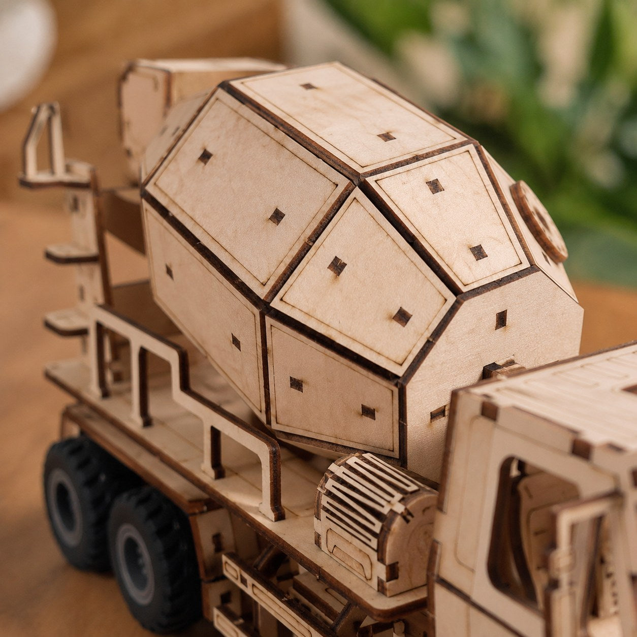Close-up of laser-cut wood details on the cement mixer drum