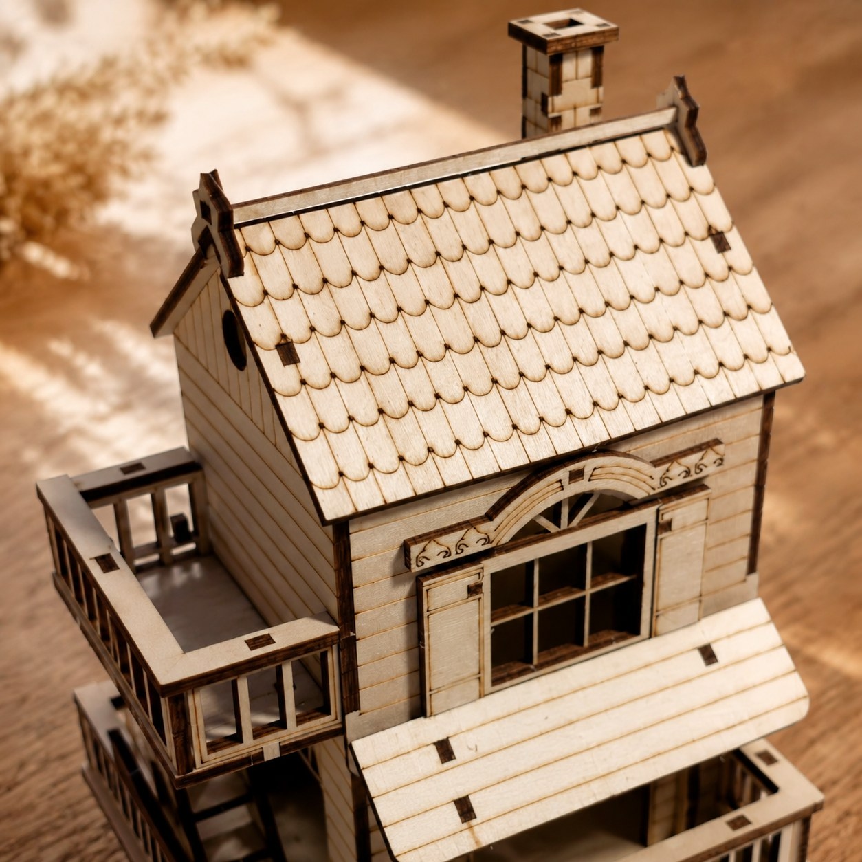 Macro close-up of the laser-cut scalloped roof and balcony details on the wooden puzzle