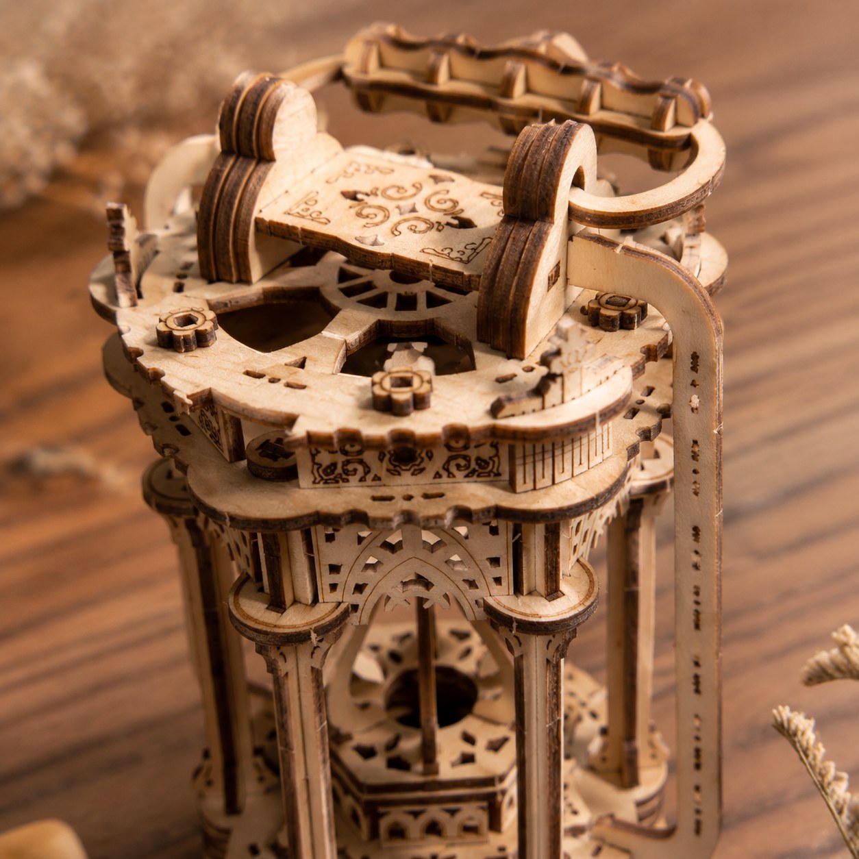Extreme close-up showing the laser-cut floral and geometric details of the wooden lantern model.