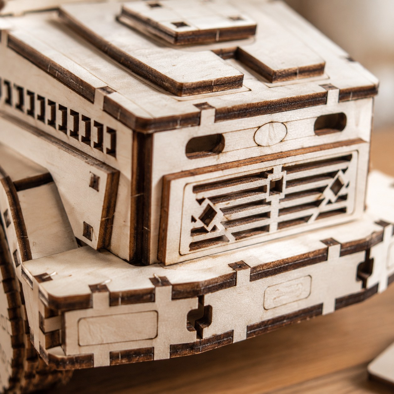 Macro close-up of the laser-cut wood details on the dump truck grille