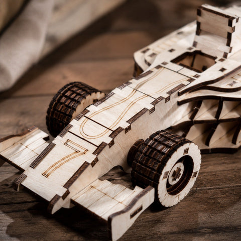 Close-up of laser-cut wood details on race car puzzle