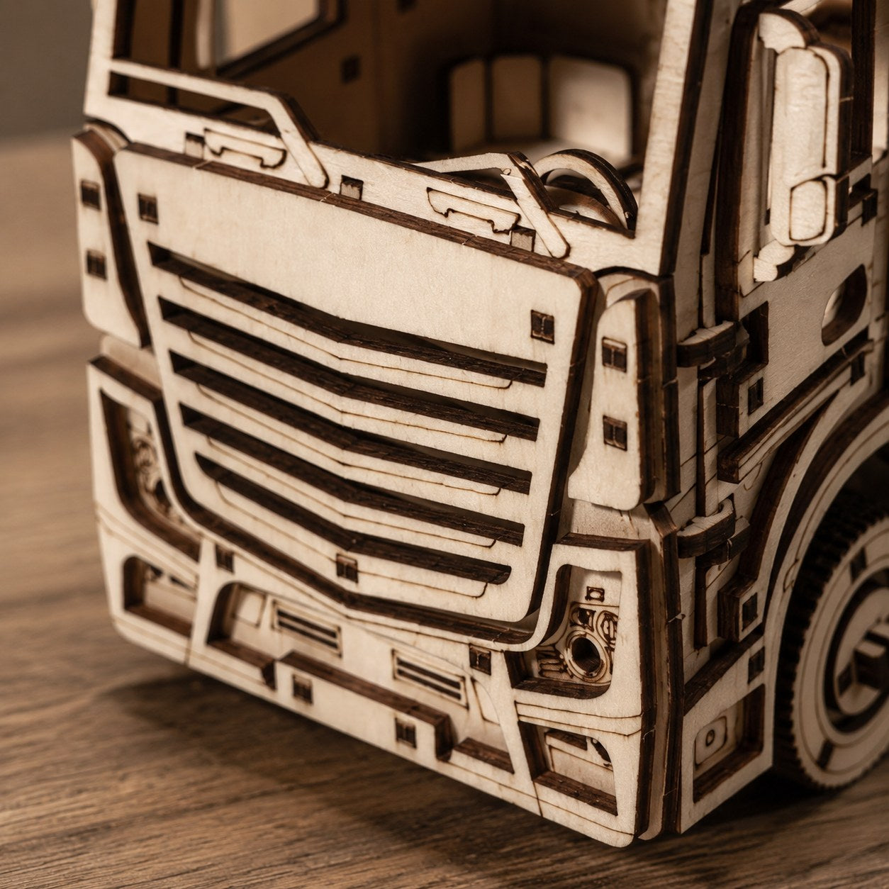 Macro close-up of the laser-cut wooden details on the semi truck grille