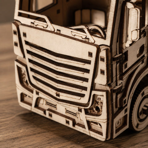 Macro close-up of the laser-cut wooden details on the semi truck grille
