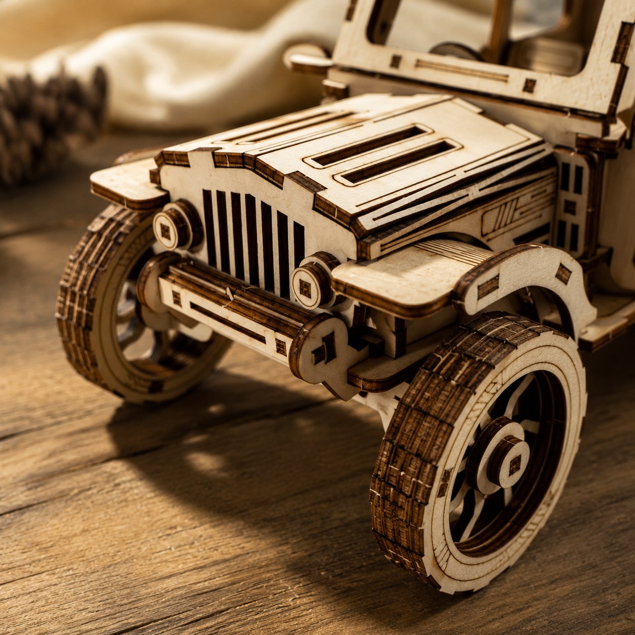 Macro close-up showing the laser-cut wood texture and front grille details of the 4x4 model.