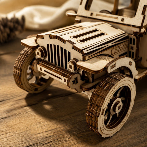 Macro close-up showing the laser-cut wood texture and front grille details of the 4x4 model.