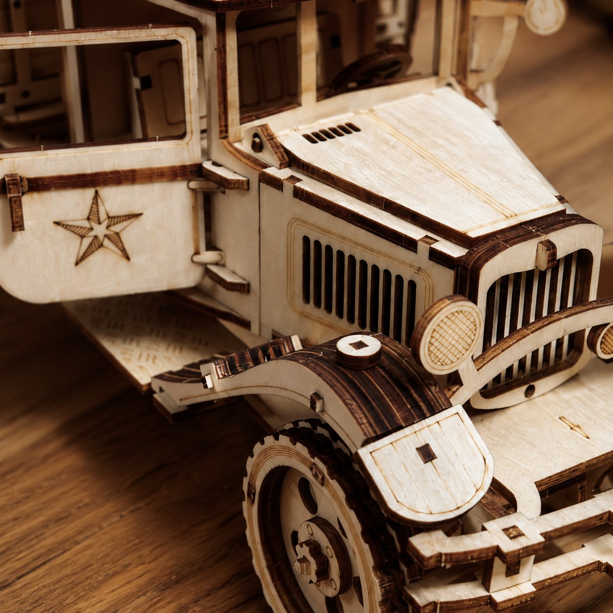 Close-up of the intricate laser-cut grille and star emblem on the wooden truck