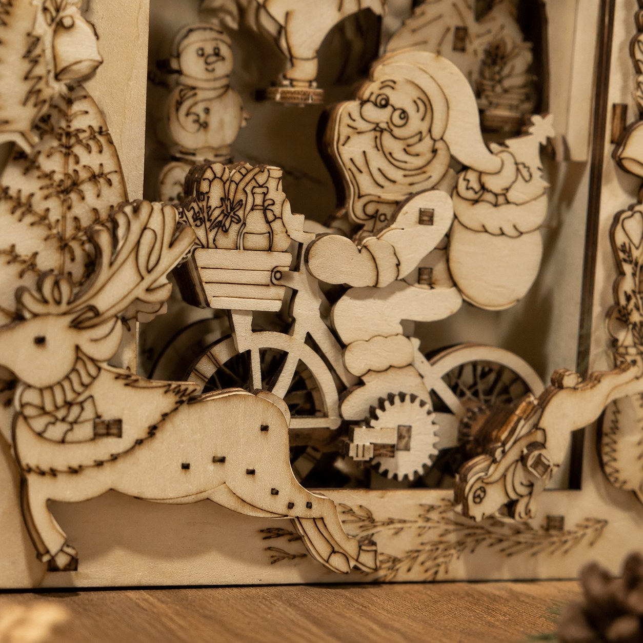 Close-up of laser-cut Santa and gears on wooden puzzle