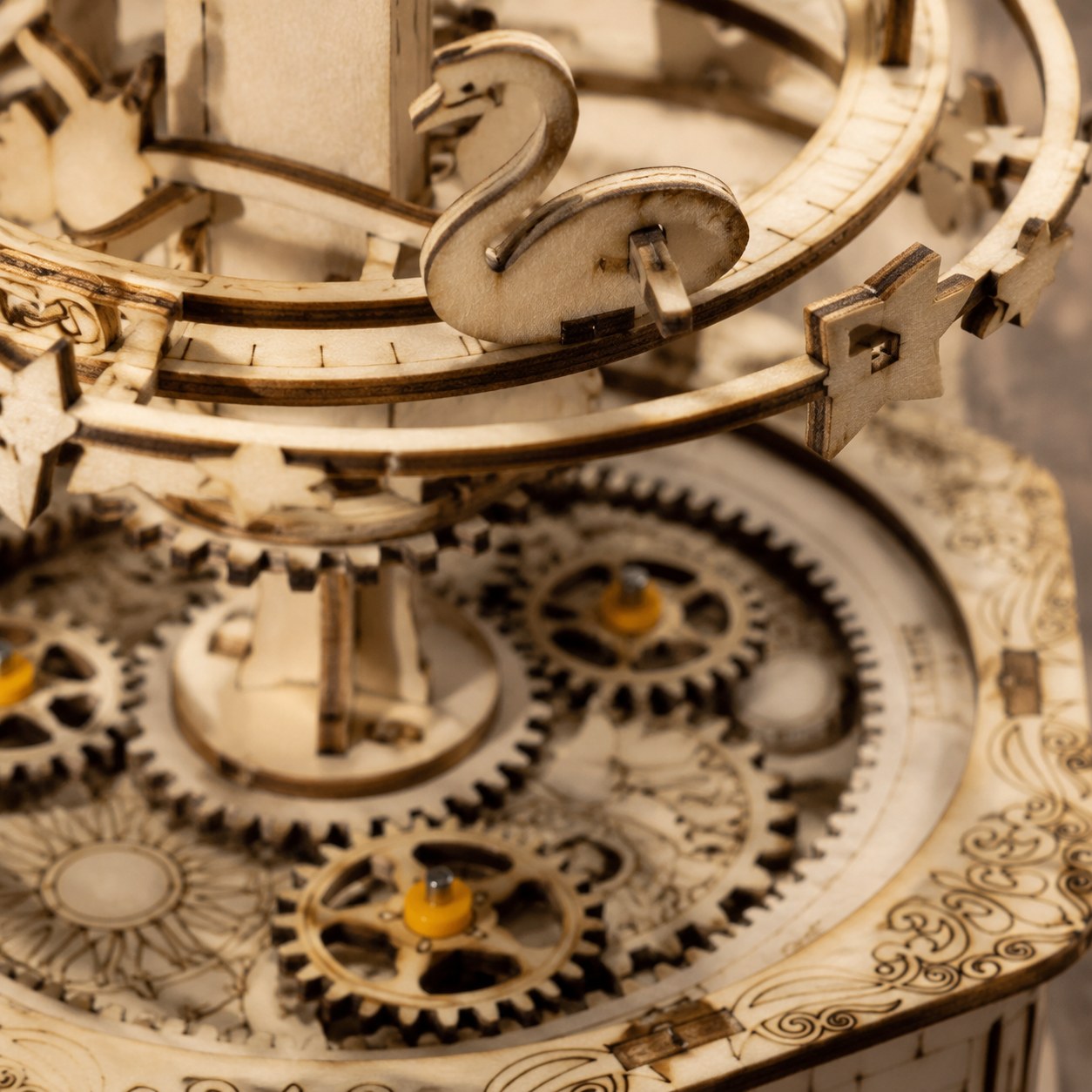 Macro close-up of the laser-cut wooden gears and orbital ring details