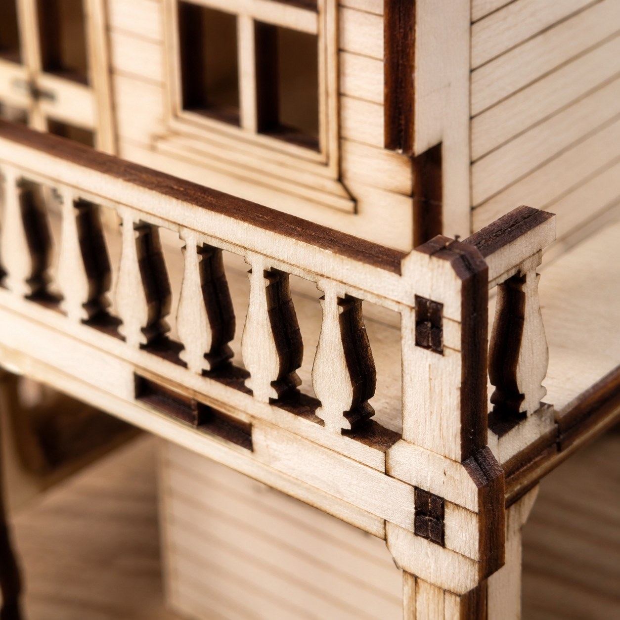 Macro close-up of the laser-cut balcony details on the wooden saloon