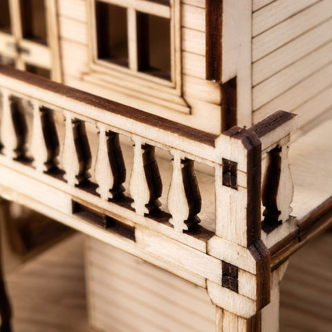 Macro close-up of the laser-cut balcony details on the wooden saloon