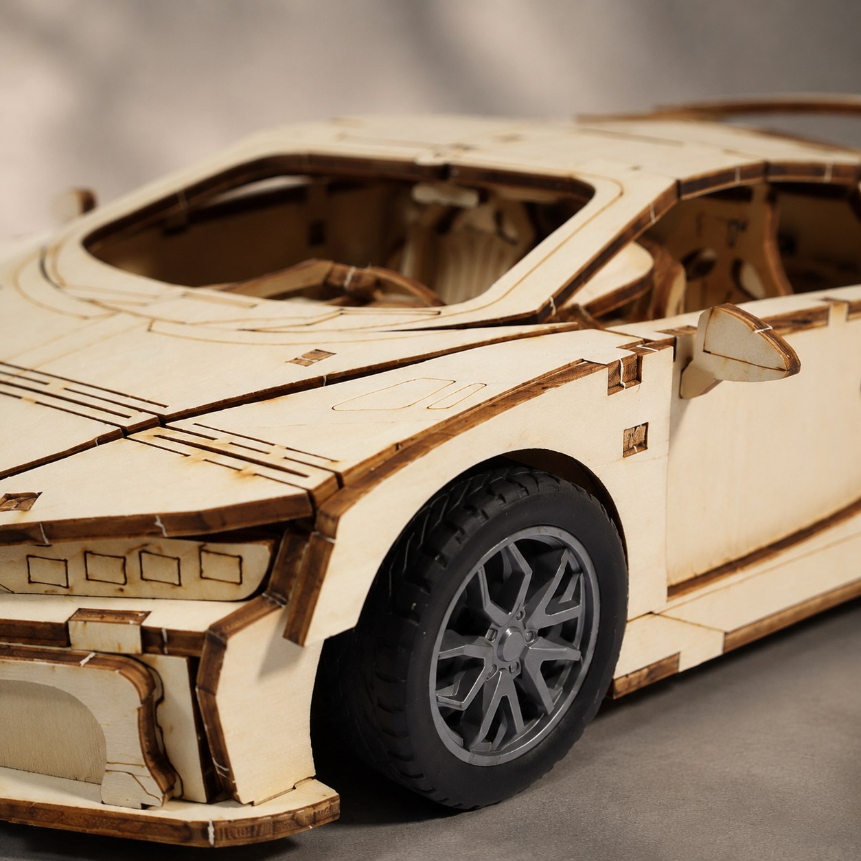 Close-up of the wooden hypercar's detailed interior and realistic tires