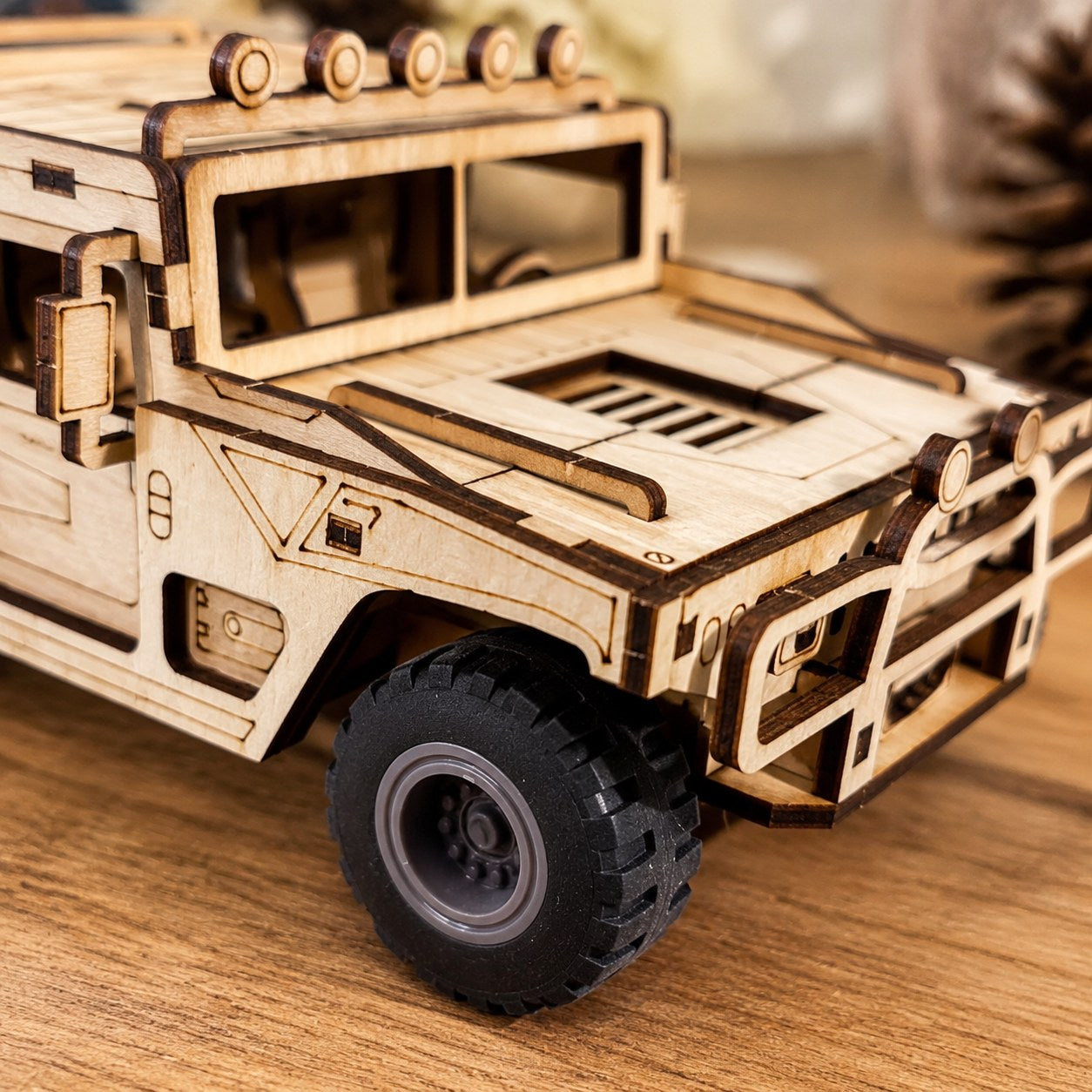 Close-up of laser-cut wood details and rubber tire on the model