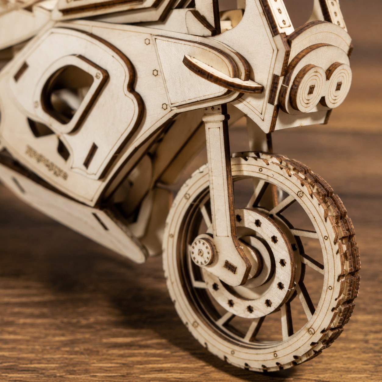 Macro close-up of the laser-cut wooden tire and engine details