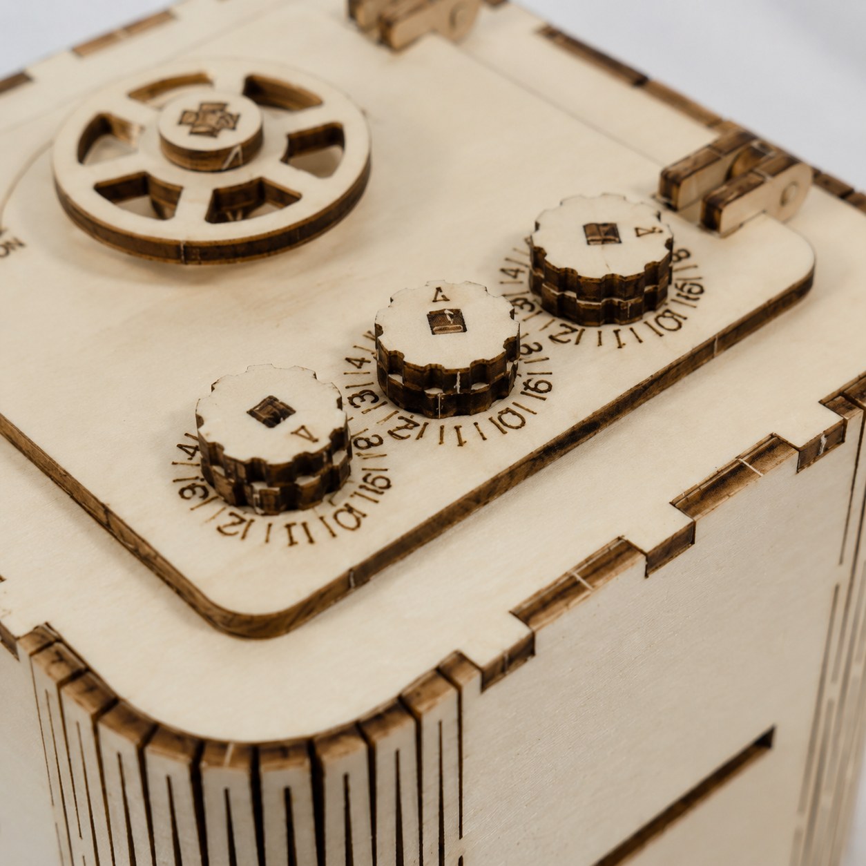 Macro close-up of wooden combination dials and laser-cut living hinge