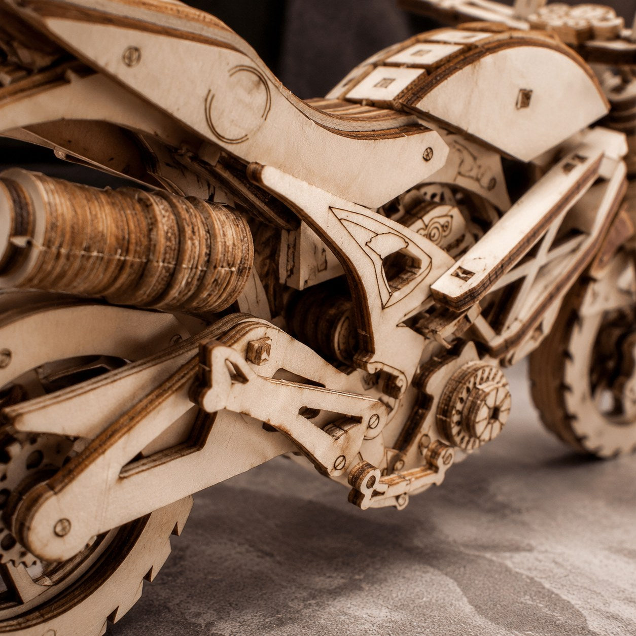 Close-up of the interlocking laser-cut wooden pieces on the cruiser motorcycle model.