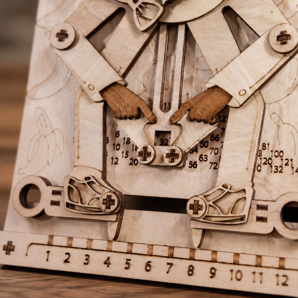 Close-up of the mechanical linkage and number window on the wooden puzzle