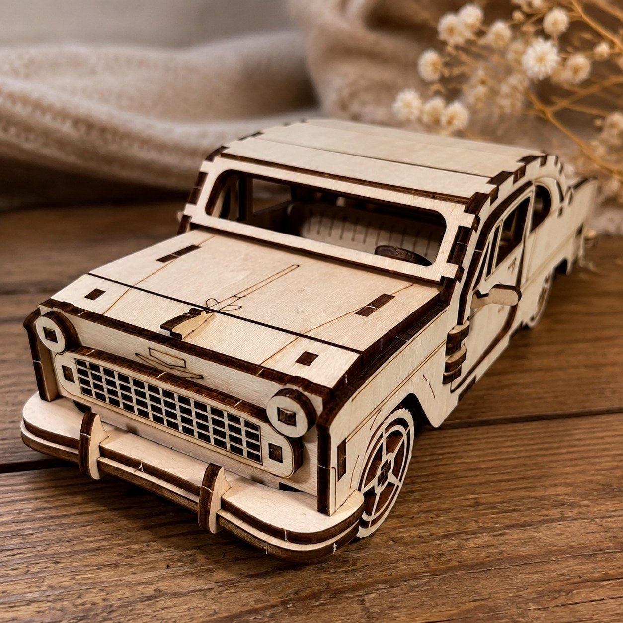 Close-up detail of the laser-cut grille on the wooden sedan model