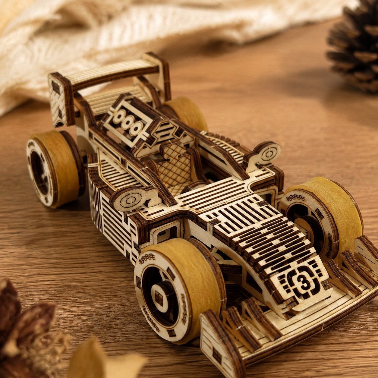 Close-up of laser-cut wood details on the race car puzzle